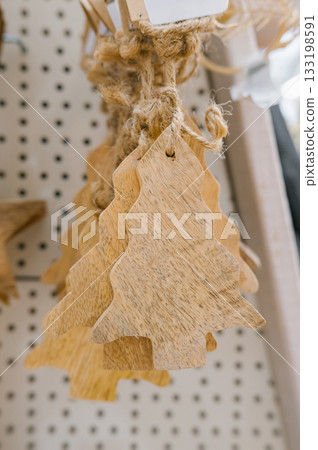 Rustic wooden christmas tree ornaments on display at market Rustic wooden christmas tree ornaments on display at market 133198591