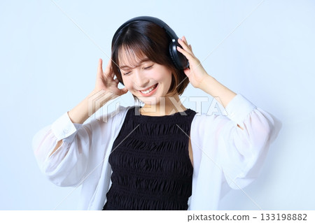 Image of a woman listening to music with enthusiasm Image of a woman listening to music with enthusiasm 133198882