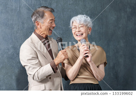 Senior men and women singing with microphones at karaoke 133199602