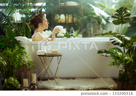 Profile of Woman Enjoying a Luxurious Bubble Bath 133200318
