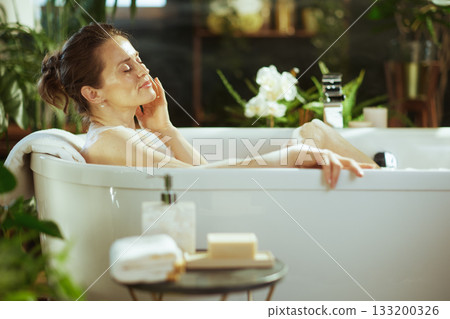 Peaceful Mid-Adult Woman in a Relaxing Bath 133200326
