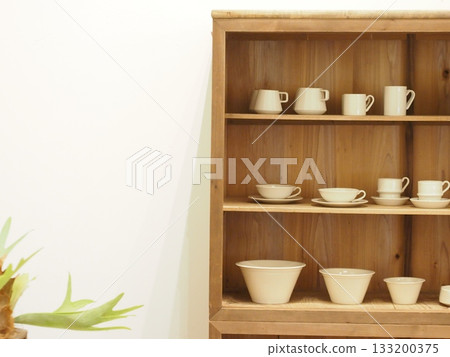 Dishes displayed on shelves Dishes displayed on shelves 133200375