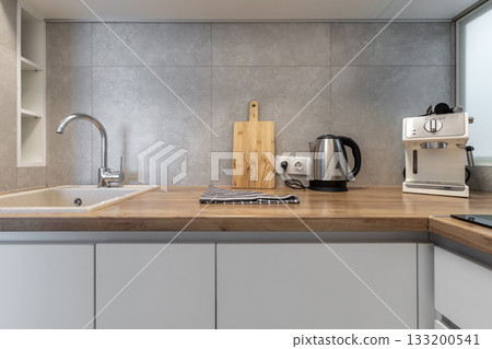 Modern Kitchen Countertop with Sink and Coffee Machine Modern Kitchen Countertop with Sink and Coffee Machine 133200541