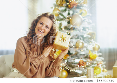 Cheerful Woman with Polka Dot Christmas Gift 133200739