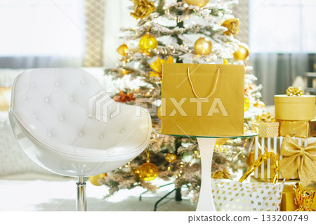 Golden Gifts and Christmas Tree in a Cozy Interior 133200749