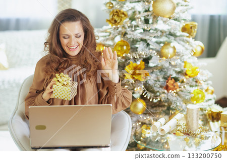 Woman with Gift Box Making Virtual Holiday Call 133200750