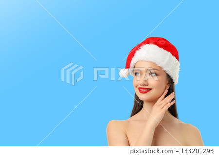 Model wearing Santa hat looking away with a smile 133201293