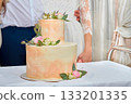 Wedding cake on the table and happy couple 133201335