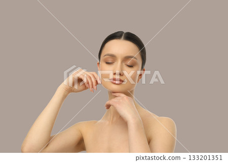 Model strikes an elegant pose, showcasing calm features Model strikes an elegant pose, showcasing calm features 133201351