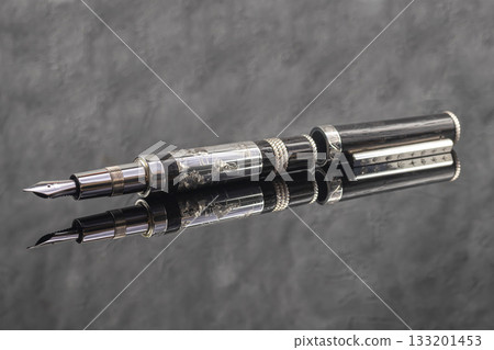 Fountain pen on a gray marble background. Boxed and unboxed. Selective focus. 133201453