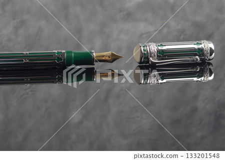 Fountain pen on a gray marble background. Boxed and unboxed. Selective focus. 133201548