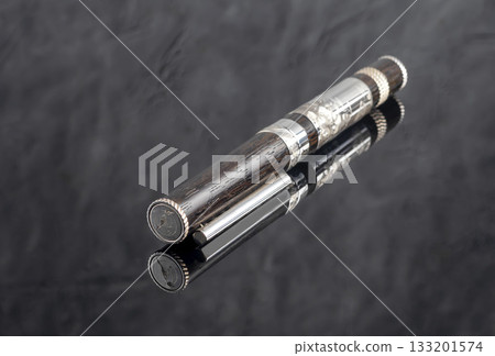 Fountain pen on a gray marble background. Boxed and unboxed. Selective focus. 133201574