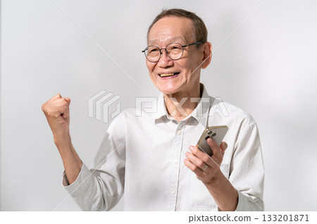 Male senior smartphone fist pump Male senior smartphone fist pump 133201871