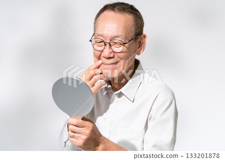 Senior man looking in a hand mirror Beauty Senior man looking in a hand mirror Beauty 133201878