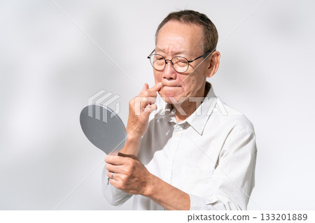 Senior man looking in a hand mirror Beauty Senior man looking in a hand mirror Beauty 133201889