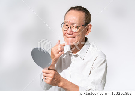 Senior man looking in a hand mirror Beauty Senior man looking in a hand mirror Beauty 133201892