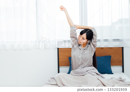 The life of a young woman who is conscious of well-being A woman waking up after a deep sleep The life of a young woman who is conscious of well-being A woman waking up after a deep sleep 133201939
