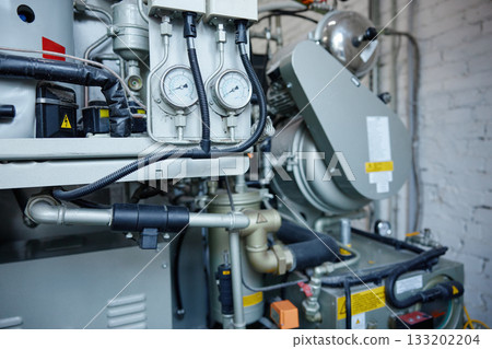 A detailed close up of a machine featuring two gauges situated on it 133202204