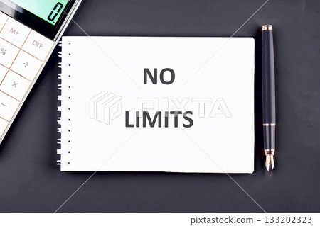 A notebook with the words NO LIMITS is on a black table with a calculator and pen, ready for work or study. Planning for growth and unlimited possibilities are coming A notebook with the words NO LIMITS is on a black table with a calculator and pen, ready for work or study. Planning for growth and unlimited possibilities are coming 133202323