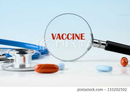 A magnifying glass emphasizes the word vaccine next to colorful pills and a stethoscope, reflecting the importance of vaccines in promoting health awareness and prevention A magnifying glass emphasizes the word vaccine next to colorful pills and a stethoscope, reflecting the importance of vaccines in promoting health awareness and prevention 133202502