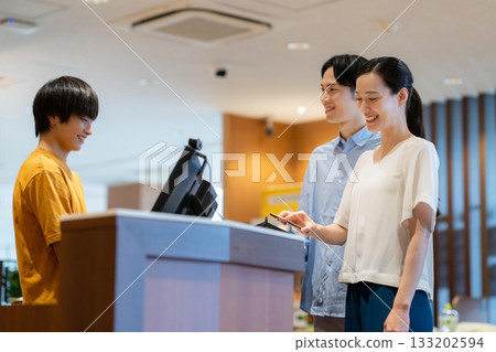 A woman shopping and making a mobile payment. Photo courtesy of Sports Club & Sauna Spa Renaissance Makuhari 24 133202594