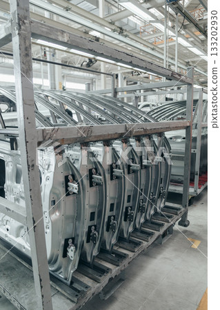 Batch of Unpainted Metal Car Doors Ready for car Assembly in the Welding shop of car assembly plant Batch of Unpainted Metal Car Doors Ready for car Assembly in the Welding shop of car assembly plant 133202930