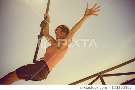 Adult woman having fun on zipline 133203592
