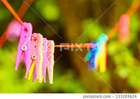 Clothes pegs on line outdoor. Housework Clothes pegs on line outdoor. Housework 133203624