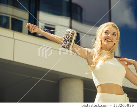 Cheerful fashionable woman in city Cheerful fashionable woman in city 133203959