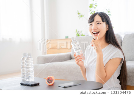 A young woman checking disaster prevention supplies 133204476