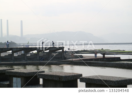 People stroll through the tiled salt fields of Jingzijian. 133204548