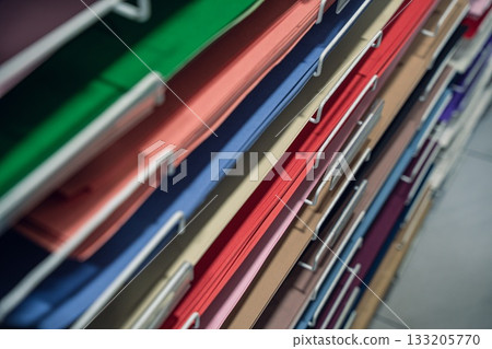 A close-up view of neatly organized colorful a1 papers stacked in a filing system A close-up view of neatly organized colorful a1 papers stacked in a filing system 133205770