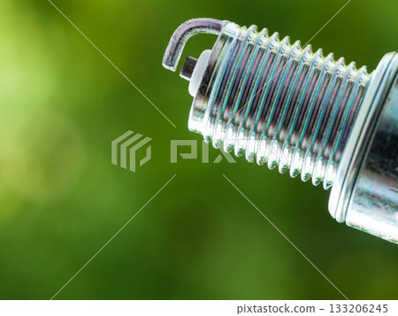 Auto service. New spark plug as spare part of car. Auto service. New spark plug as spare part of car. 133206245
