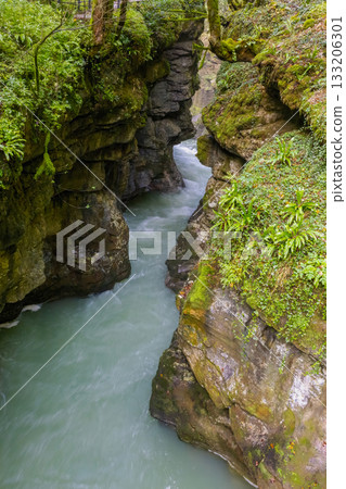 rapid flow of the river in a deep gorge 133206301