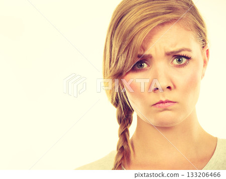 Teenage girl in braid hair making angry face 133206466
