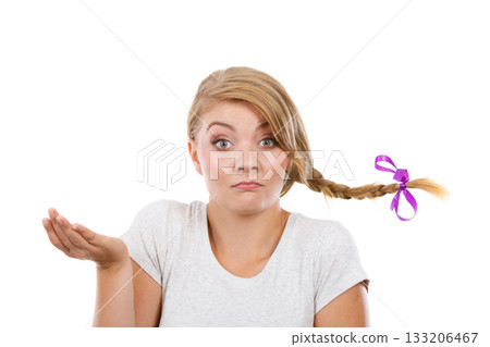 Teenage girl in braid hair making thinking face Teenage girl in braid hair making thinking face 133206467