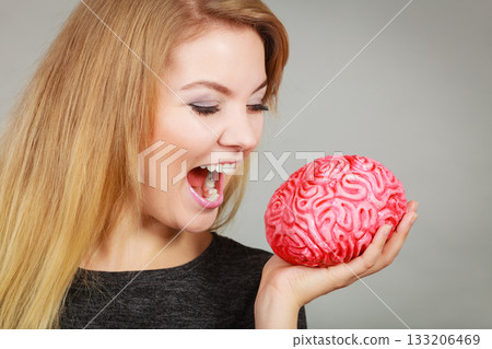 Crazy woman holding brain wanting to eat it Crazy woman holding brain wanting to eat it 133206469