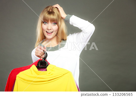 woman customer holding hangers with clothes woman customer holding hangers with clothes 133206565