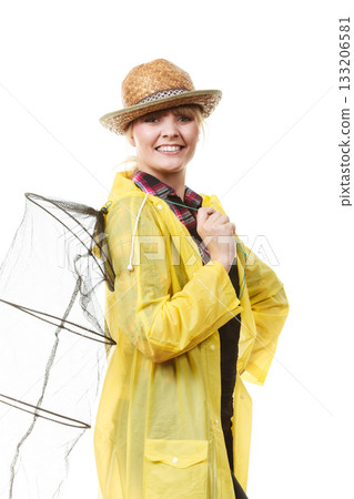Happy woman holding empty fishing keepnet Happy woman holding empty fishing keepnet 133206581