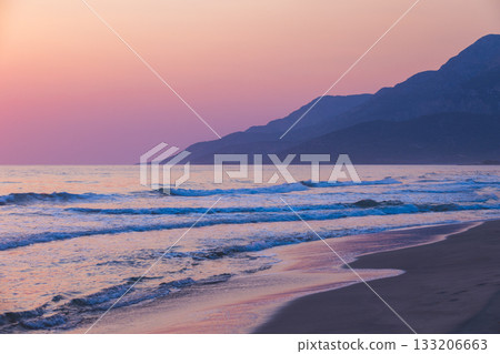 Tranquil seaside scene featuring gentle waves, a sandy shoreline Tranquil seaside scene featuring gentle waves, a sandy shoreline 133206663