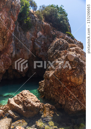 Rocky coastal landscape photo features rugged formations. Kalkan, Turkey Rocky coastal landscape photo features rugged formations. Kalkan, Turkey 133206665