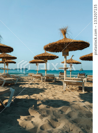 Sunny beach with straw 133207135