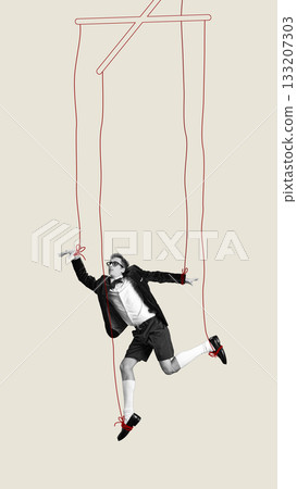 Conceptual collage of man controlled by red puppet strings with emotional resistance 133207303