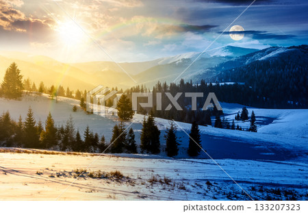 spruce forested hills of mountain ridge in winter. day and night time change concept. gorgeous nature scenery with snow covered hillside and meadows with sun and moon at twilight. equality and shift 133207323