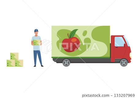 A truck driver loads boxes of apple juice into a truck. A man holds a basket of apples by a red delivery truck 133207969