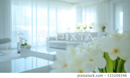 Bright indoor lounge with white furniture and greenery 133208346