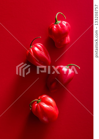 Red chili pepper habanero on red background. Top view. Red chili pepper habanero on red background. Top view. 133208757
