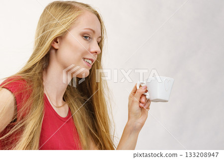 Blonde girl with coffee cup Blonde girl with coffee cup 133208947