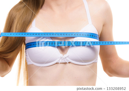 Girl measuring her chest breasts bust size Girl measuring her chest breasts bust size 133208952