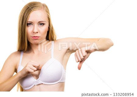 Woman dissatisfied with size of bra breasts Woman dissatisfied with size of bra breasts 133208954